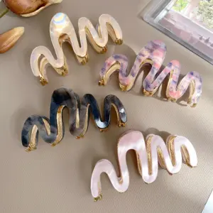 Wave - Geschwungene Haarklammer mit goldenen Akzenten